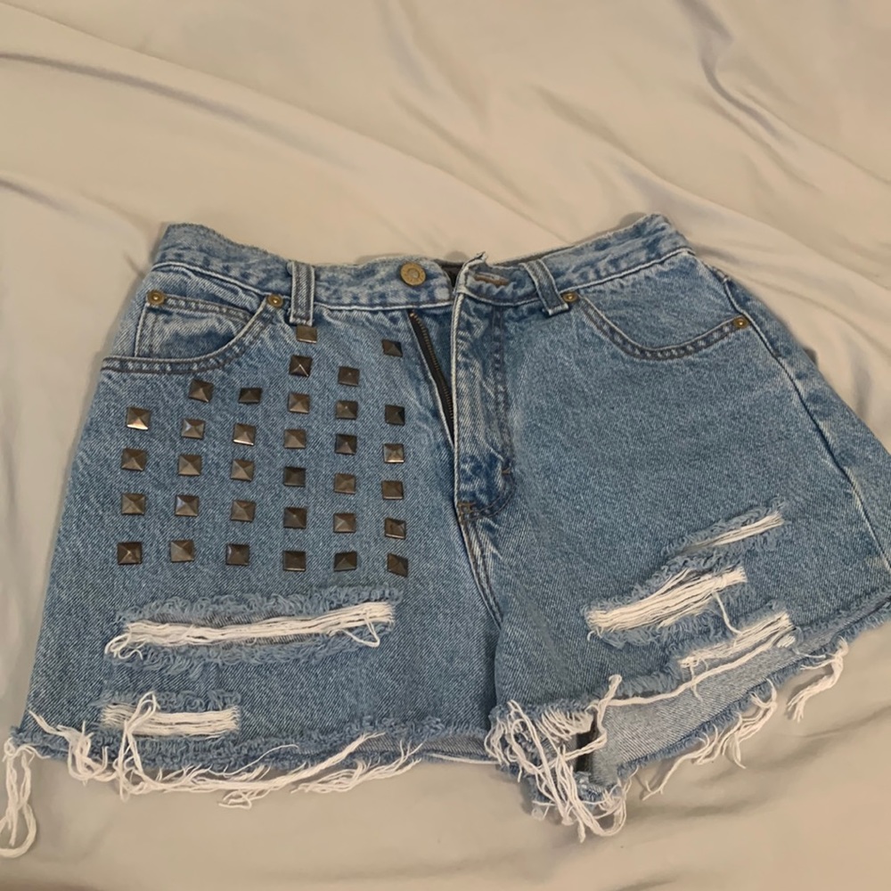 Custom high waisted denim distressed and studded shorts.